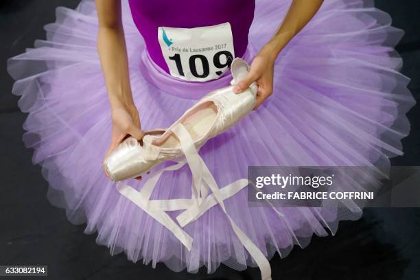 Young dancer prepares her shoes prior to a run-through classical variation of the 45th International Ballet Competition "Prix de Lausanne" on January...