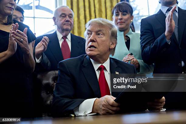 President Donald Trump pauses after signing an executive order in the Oval Office of the White House surrounded by small business leadersJanuary 30,...