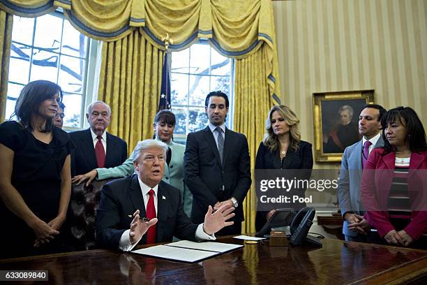 President Donald Trump speaks before signing an executive order surrounded by small business leaders in the Oval Office of the White House January...