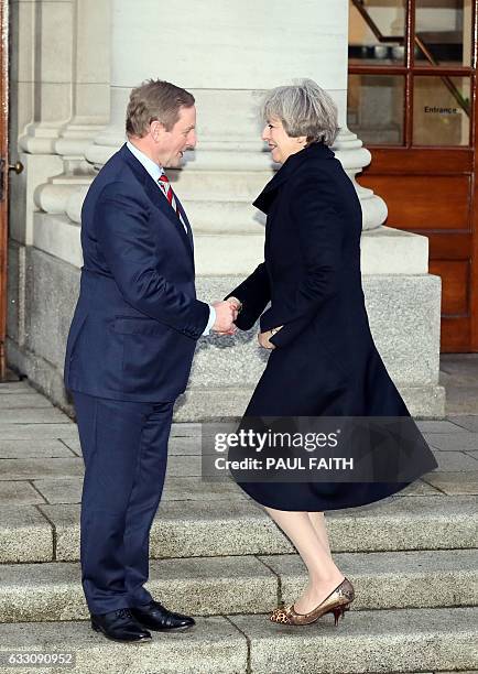 Irish Prime Minister Enda Kenny greets British Prime Minister Theresa May at the goverment buildings in Dublin on January 30, 2017. / AFP / Paul FAITH