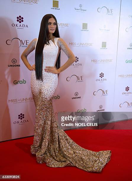 Former Miss Universe Pia Wurtzbach poses as she arrives at the Miss Universe after-party red carpet event at a hotel in Manila on January 30, 2017....