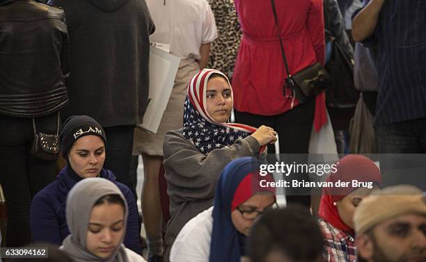 Muslim women pray as hundreds stand in support of their rights on the departure level of the Tom Bradley International Terminal to protest Donald...