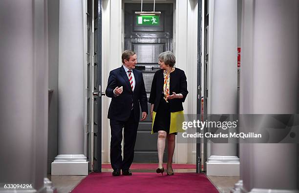 British Prime Minister Theresa May and Irish Taoiseach Enda Kenny make their way to a joint press conference at Government Buildings on January 30,...