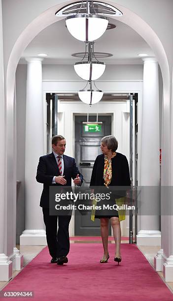 British Prime Minister Theresa May and Irish Taoiseach Enda Kenny make their way to a joint press conference at Government Buildings on January 30,...