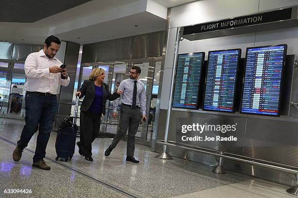 Rep. Ileana Ros-Lehtinen walks with members of her staff, Reimy Benitez and Keith Fernandez, after speaking to the media about President Donald...