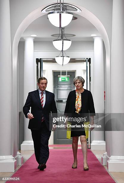 British Prime Minister Theresa May and Irish Taoiseach Enda Kenny make their way to a joint press conference at Government Buildings on January 30,...