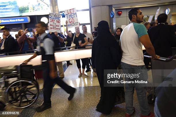 Passengers arrive at LAX as protest continue over President Trump's travel ban at the Tom Bradley Terminal at LAX on January 29, 2017 in Los Angeles,...