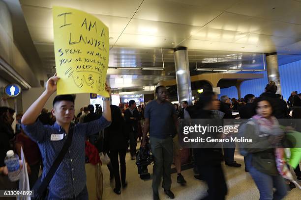 Attorney Eric Chen offers his help as people continue to protest President Trump's travel ban at the Tom Bradley Terminal at LAX on January 29, 2017...