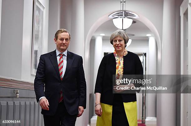 British Prime Minister Theresa May and Irish Taoiseach Enda Kenny make their way to a joint press conference at Government Buildings on January 30,...