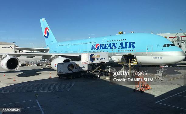 Korean Air plane sits at a gate at Los Angeles international airport on Januray 30, 2017. / AFP / Daniel SLIM