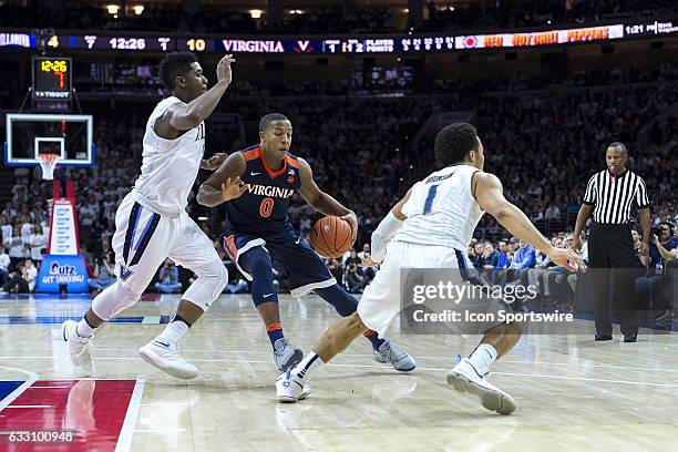 Virginia Cavaliers guard Devon Hall fakes his way around Villanova Wildcats guard Jalen Brunson to run into Villanova Wildcats forward Kris Jenkins...