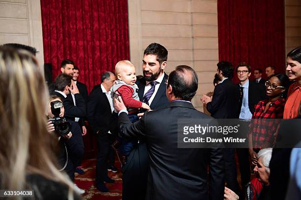 Nikola Karabatic of the France handball team, who have just won the World Championships, introduces his son Alek to French president Francois...