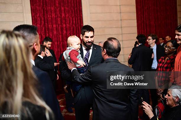 Nikola Karabatic of the France handball team, who have just won the World Championships, introduces his son Alek to French president Francois...