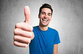 happy smiling man giving thumbs up