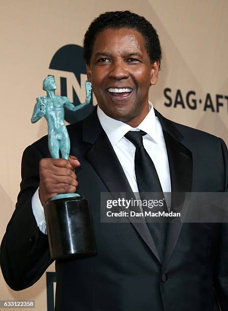 Denzel Washington poses in the press room with his award for Outstanding Performance by a Male Actor in a Leading Role for 'Fences' at the 23rd...