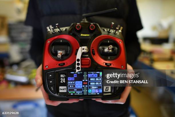 Drone racing champion Luke Bannister poses for a photograph as with the radio control of his first-person view drone in Wiltshire, western England,...