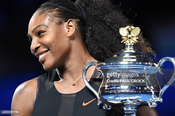 Serena Williams of the US holds up the trophy following her victory over Venus Williams of the US in the women's singles final on day 13 of the...