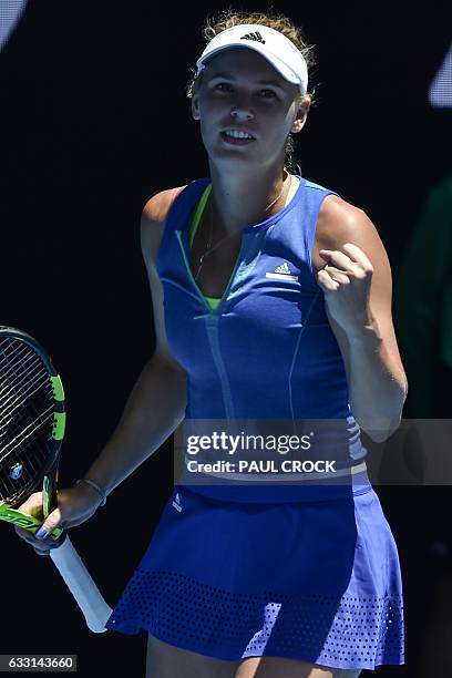 Denmark's Caroline Wozniacki celebrates after victory against Croatia's Donna Vekic during their women's singles second round match on day four of...