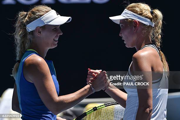 Denmark's Caroline Wozniacki shakes hands with Croatia's Donna Vekic after winning their women's singles second round match on day four of the...