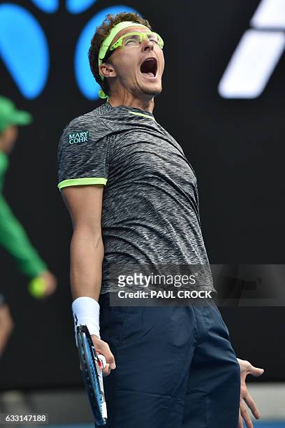 Uzbekistan's Denis Istomin celebrates victory against Serbia's Novak Djokovic during their men's singles second round match on day four of the...