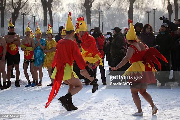 Winter swimmers wearing chick hats dance to celebrate the Year of the Rooster at Beiling Park on January 31, 2017 in Shenyang, Liaoning Province of...