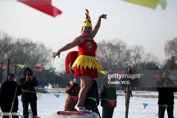 Winter swimmer wearing a chick hat poses for photos to celebrate the Year of the Rooster at Beiling Park on January 31, 2017 in Shenyang, Liaoning...