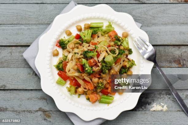 Rice noodles and vegetables tossed in a creamy peanut sauce is an easy-to-make dish that's ready in minutes.