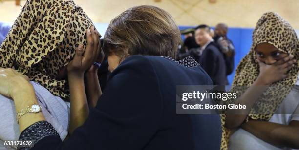 Twelve-year-old Muna Abdi breaks down and is comforted by Massachusetts Attorney General Maura Healey after asking her a question near the end of a...