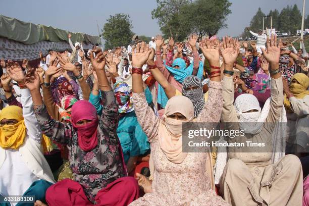 Women activists from Jat community raise their hands during their protest for demand for reservations in government jobs at Jassia village on January...