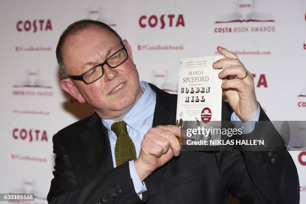 British author Francis Spufford poses with his First Novel Award winning book 'Golden Hill' as he arrives for the 2016 Costa Book Awards in London on...