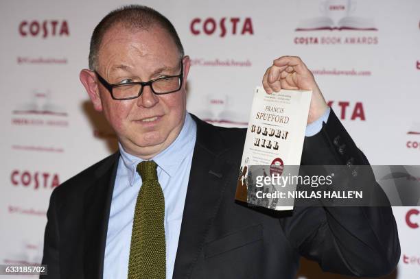 British author Francis Spufford poses with his First Novel Award winning book 'Golden Hill' as he arrives for the 2016 Costa Book Awards in London on...