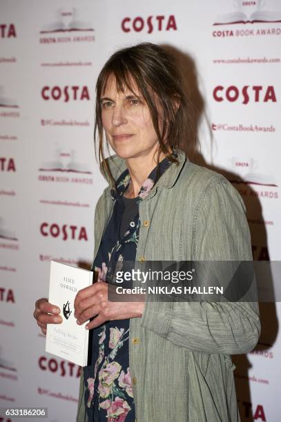 British poet Alice Oswald poses with her Poetry Award winning book 'Falling Awake' as she arrives for the 2016 Costa Book Awards in London on January...
