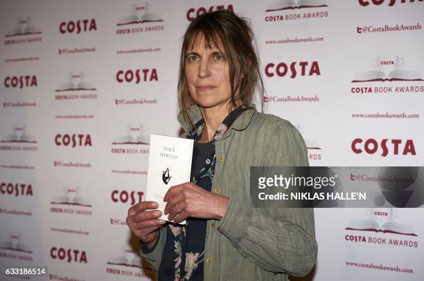British poet Alice Oswald poses with her Poetry Award winning book 'Falling Awake' as she arrives for the 2016 Costa Book Awards in London on January...