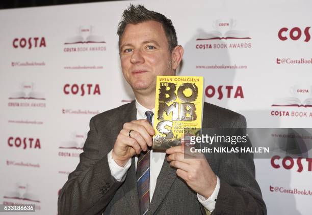 British author Brian Conaghan poses with his Children's Book Award winning book 'The Bombs That Brought Us Together' as he arrives for the 2016 Costa...