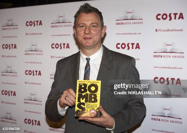 British author Brian Conaghan poses with his Children's Book Award winning book 'The Bombs That Brought Us Together' as he arrives for the 2016 Costa...