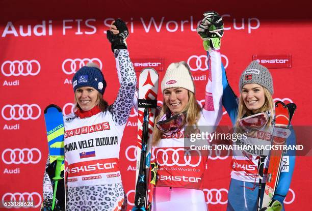 First place US Mikaela Shiffrin celebrates with second place Slovakia's Veronika Velez Zuzulova and third place Norway's Nina Loeseth during a...
