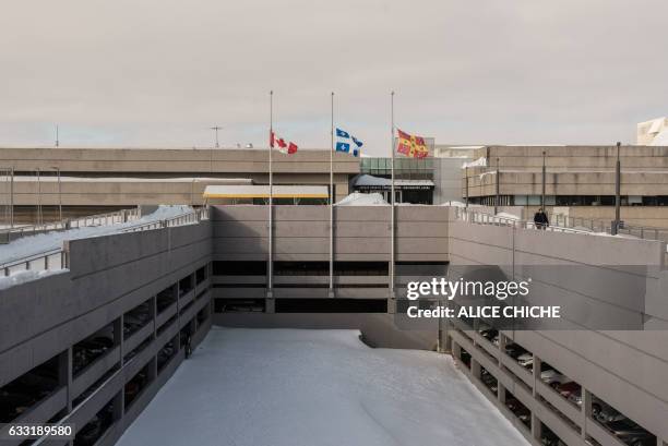 The flags of Canada, Quebec and Universite Laval are at half-mast on the campus of Laval University on January 31, 2017 in Quebec City, Quebec. - A...