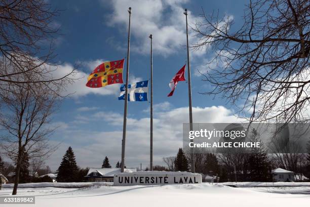 The flags of Universite Laval, Quebec and Canada are at half-mast on campus January 31, 2017 in Quebec City, Quebec. A Canadian political science...