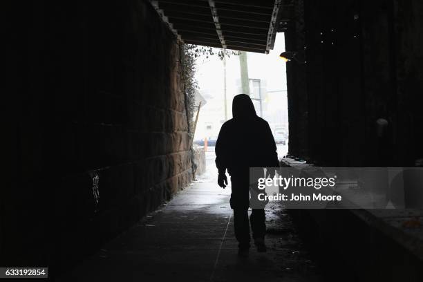 An immigrant walks to a day labor pick-up site on January 31, 2017 in Stamford, Connecticut. The city of Stamford has an official zone for employers...