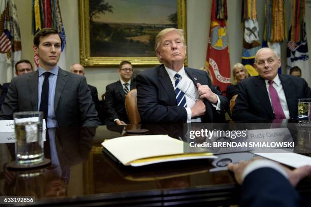 Senior Advisor Jared Kushner and Secretary of Homeland Security John Kelly listen while US President Donald Trump puts his papers away at the...