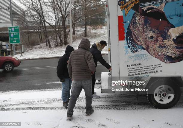 An employer opens the back door of a U-Haul truck while picking up immigrants at a day labor site on January 31, 2017 in Stamford, Connecticut. The...