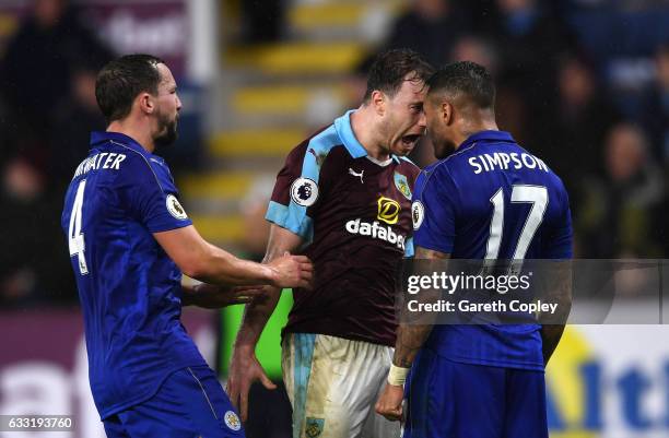 Ashley Barnes of Burnley and Danny Simpson of Leicester City square off while Danny Drinkwater of Leicester City tries to separate them during the...