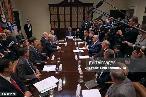 President Donald Trump delivers remarks at the beginning of a meeting with his staff and government cyber security experts in the Roosevelt Room at...
