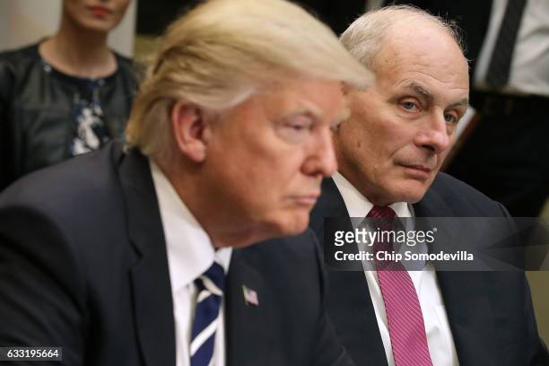 Homeland Security Secretary John Kelly listens as U.S. President Donald Trump delivers remarks at the beginning of a meeting with government cyber...