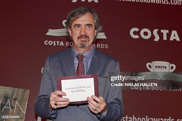 Irish author Sebastian Barry poses with his award after winning the overall book of the year prize for his book 'Days Without End' at the 2016 Costa...