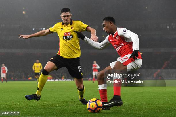 Alex Iwobi of Arsenal and Craig Cathcart of Watford compete for the ball during the Premier League match between Arsenal and Watford at Emirates...