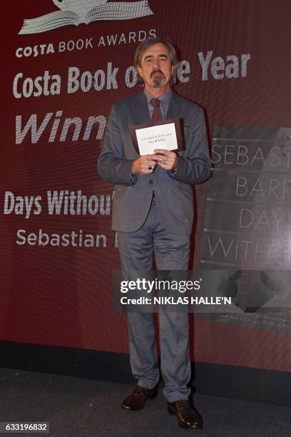 Irish author Sebastian Barry poses with his award after winning the overall book of the year prize for his book 'Days Without End' at the 2016 Costa...