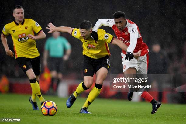 Craig Cathcart of Watford and Alex Iwobi of Arsenal compete for the ball during the Premier League match between Arsenal and Watford at Emirates...