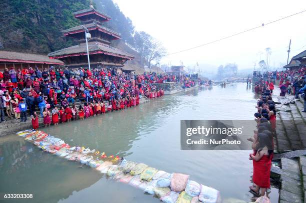 Nepalese Devotees performing rituals on Triveni River during Madhav Narayan Festival or Swasthani Brata Katha festival celebrated at Panauti Village,...