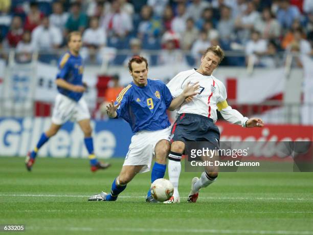 David Beckham of England tackles Fredrik Ljunberg of Sweden in the first half of the England v Sweden, Group F, World Cup Group Stage match played at...